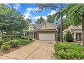 Inviting home with a brick and siding exterior, attached garage, and a well-kept front yard at 1608 Heritage Links Dr, Wake Forest, NC 27587