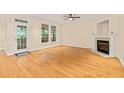 Bright living room with hardwood floors, fireplace, and access to a porch at 1870 Lennox Dr, Garner, NC 27529