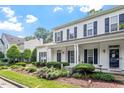 Beautiful home featuring blue shutters, a manicured lawn, and neatly trimmed shrubbery at 2010 Silky Dogwood Trl, Apex, NC 27502