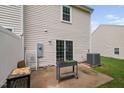 Back patio with sliding doors, an AC unit, and a garden planter at 2018 Grassy Banks Dr, Raleigh, NC 27610