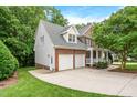 Beautiful home showcasing a spacious driveway and an attached two-car garage at 203 Witheridge Ct, Apex, NC 27502