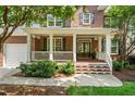 Inviting front porch with white railing, offering a perfect spot to relax at 203 Witheridge Ct, Apex, NC 27502