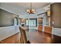 Open dining area featuring dark wood table, woven chairs, and views to the living room with a fireplace at 204 Muirfield Ln, Clayton, NC 27527