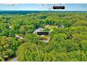 Stunning aerial view of a home nestled amongst mature trees and within close proximity to downtown Cary at 2109 W Marilyn Cir, Cary, NC 27513