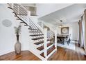 Modern staircase with wood treads, white risers, and metal railings leading to a dining area at 2109 W Marilyn Cir, Cary, NC 27513