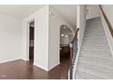 Inviting foyer with hardwood floors, staircase, and arched doorway leading to the kitchen at 220 Mount Evans Dr, Durham, NC 27705