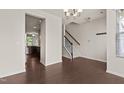 A brightly lit living room showcases hardwood flooring and a view of the staircase at 220 Mount Evans Dr, Durham, NC 27705
