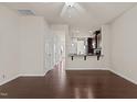 Spacious living room with hardwood floors, ceiling fan, and an open layout to the kitchen at 220 Mount Evans Dr, Durham, NC 27705