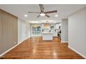 Spacious open-concept living room with wood floors and open to kitchen and sliding doors to deck at 2200 Wyman Pl, Durham, NC 27707