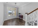 Bright foyer features hardwood floors, white trim, and a modern light fixture at 2500 Plowridge Rd, Fuquay Varina, NC 27526