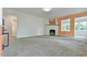 Bright living room with modern fireplace, neutral carpet and an open layout with an adjacent room at 2602 Francis St, Durham, NC 27707