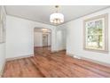 Open dining room with hardwood floors and natural light from large window at 2714 Wedgedale Ave, Durham, NC 27703