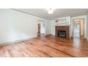 Spacious living room featuring wood floors and a charming brick fireplace at 2714 Wedgedale Ave, Durham, NC 27703