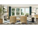Cozy living room featuring large windows, comfortable seating, and stylish decor at 2968 Hanging Valley Way, Wake Forest, NC 27587
