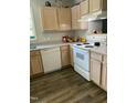 Kitchen featuring white appliances, light wood cabinets, and wood-look flooring at 3000 Centennial Woods Dr # 302, Raleigh, NC 27603