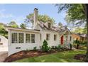 Exterior view of home with brick chimney, multiple windows, and a red front door at 3210 Merriman Ave, Raleigh, NC 27607