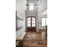 Grand foyer with high ceilings, hardwood floors, a bench, and large windows for natural light at 329 Royal Delta Dr, Cary, NC 27519