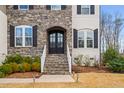 Inviting front entrance with stone steps, arched entryway, and professionally landscaped yard at 329 Royal Delta Dr, Cary, NC 27519