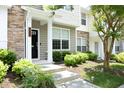 Inviting home exterior featuring a black front door, stone accents, and green landscaping at 365 Red Elm Dr, Durham, NC 27713