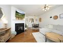 Cozy living room featuring a fireplace with a TV, hardwood floors, and a comfortable sofa at 365 Red Elm Dr, Durham, NC 27713