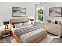Well-lit bedroom with a large window, neutral décor, and stylish furnishings at 4509 Cobble Creek Ln, Raleigh, NC 27616
