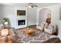 Bright living room featuring a fireplace, hardwood floors, neutral decor, and comfortable seating at 4509 Cobble Creek Ln, Raleigh, NC 27616