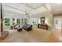 Bright living room featuring a fireplace, large windows, and comfortable seating at 671 Bear Tree Crk, Chapel Hill, NC 27517