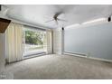 Bright living room featuring a large window, plush carpeting, and ceiling fan at 712 Beaver Dam Rd, Raleigh, NC 27607