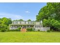 Charming two-story home featuring a wrap-around porch and lush landscaping at 771 Cedar Grove Church Rd, Roxboro, NC 27574