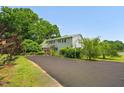 Charming home with a long driveway, green lawn, and mature trees at 771 Cedar Grove Church Rd, Roxboro, NC 27574