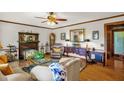 Cozy living room features a wooden fireplace, plush seating, and elegant decor at 771 Cedar Grove Church Rd, Roxboro, NC 27574