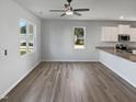 Spacious living area featuring sleek floors and abundant natural light from large windows at 8891 Commons Townes Dr, Raleigh, NC 27616