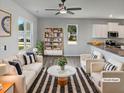 Bright living room with modern furnishings and open layout flowing into the kitchen at 8891 Commons Townes Dr, Raleigh, NC 27616