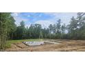 Foundation under construction showing concrete slab and rebar on a wooded lot at 90 Caspian Ct, Lillington, NC 27546
