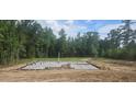 Foundation under construction showing concrete slab and rebar on a wooded lot at 90 Caspian Ct, Lillington, NC 27546