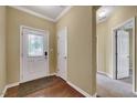 Inviting entryway featuring a decorative front door, coat closet, and hardwood floors at 921 Shefford Town Dr, Rolesville, NC 27571