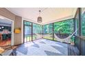 Relaxing screened-in porch with hammocks, stylish rug, and views of the surrounding greenery at 973 Rebecca Ln, Siler City, NC 27344