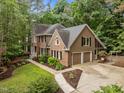 A brick and siding home has an attached two-car garage and well-maintained landscaping at 1004 Staffield Lane Ln, Chapel Hill, NC 27516