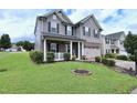 Charming two-story house with a well-kept lawn, mature shrubs, and a two-car garage at 101 Claystone Dr, Gibsonville, NC 27249