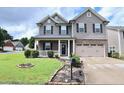 Beautiful two-story home with a well-maintained lawn and tasteful landscaping at 101 Claystone Dr, Gibsonville, NC 27249