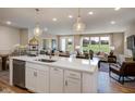 Open layout with central island, seamlessly connecting kitchen, dining, and living areas at 1033 Masters Place Way # 110, Durham, NC 27703