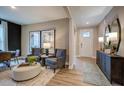 Inviting living room with wood floors, stylish decor, and ample natural light entering through the front door at 1033 Masters Place Way # 110, Durham, NC 27703