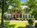 Lovely two-story home with brick and siding, complemented by lush greenery and manicured lawn at 105 Spring Bud Dr, Cary, NC 27513