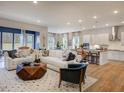 Spacious living room with a white sofa, modern furniture, and an open kitchen at 1107 Masters Place Way # 155, Durham, NC 27703