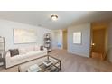 Cozy upstairs living space with plush carpeting, neutral tones, and a comfortable sofa at 1172 Solace Way, Rolesville, NC 27571