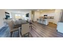 Open concept living room, dining room, and kitchen featuring an island with counter seating at 1172 Solace Way, Rolesville, NC 27571