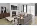 Bright living room with fireplace, wood floors, comfortable seating, and natural light at 1205 Masters Place Way # 183, Durham, NC 27703