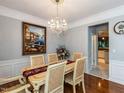 Bright dining room with chandelier lighting, traditional furnishings, and an open view to the kitchen at 122 Button Rd, Morrisville, NC 27560