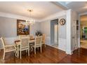 Elegant dining room featuring hardwood floors, a chandelier, and traditional decor with a large painting at 122 Button Rd, Morrisville, NC 27560