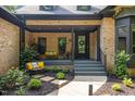 Inviting front porch with comfortable seating and stylish decor, creating a welcoming outdoor space at 13121 Melvin Arnold Rd, Raleigh, NC 27613